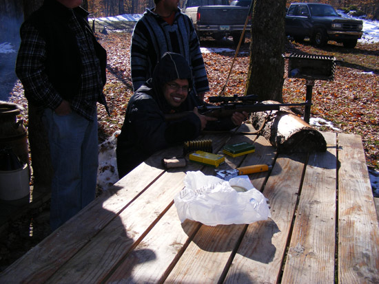 Evan shooting rifle as Chad and Jack watches